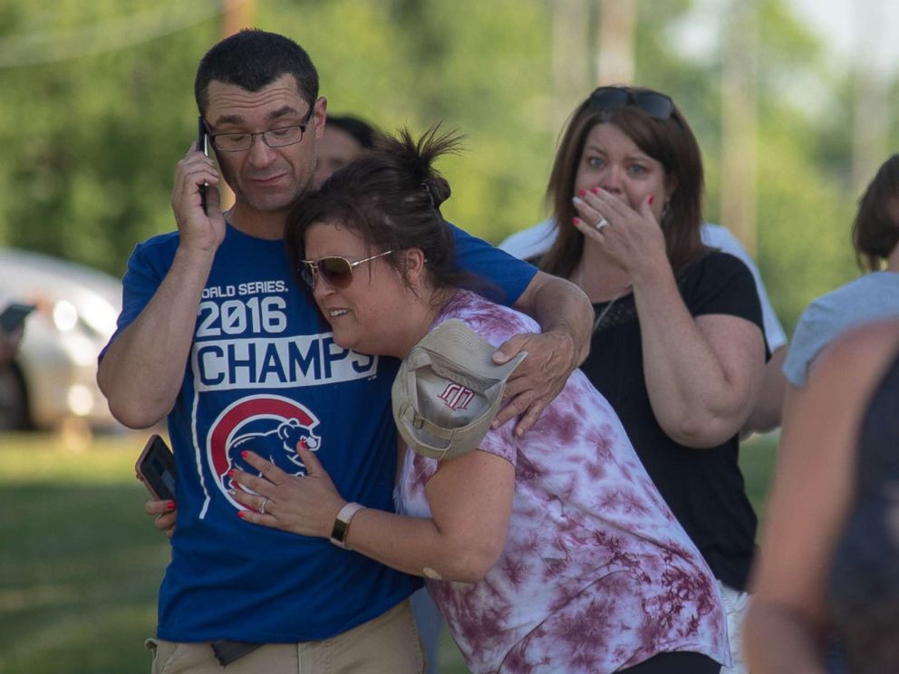 PHOTO: Parents comfort each other as they wait outside Noblesville West Middle School after a shooting on May 25, 2018, in Noblesville, Ind.