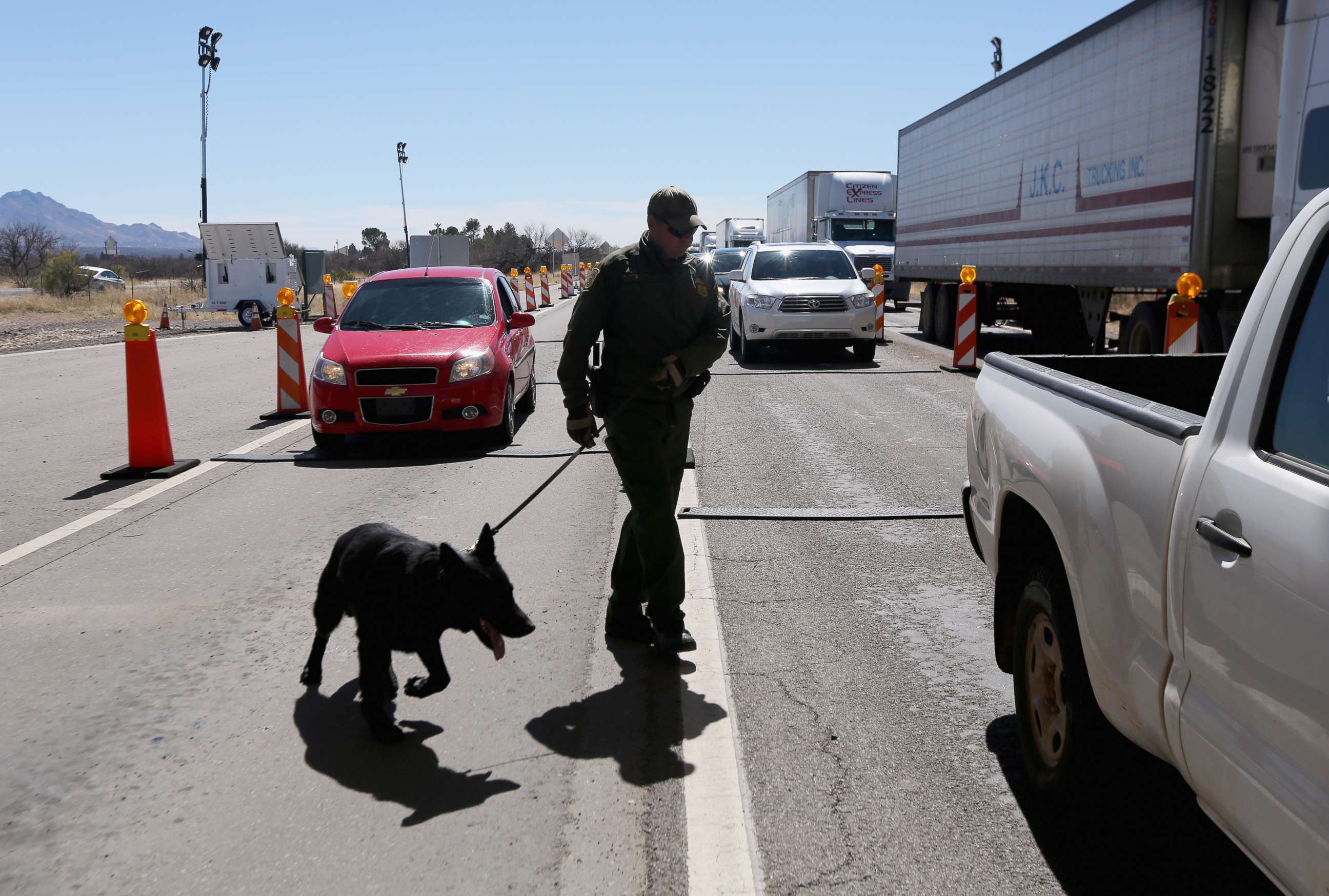 PHOTO: A U.S. Border Patrol agent and drug sniffing German Shepherd prepare to search vehicles for drugs at a checkpoint near the U.S. Mexico border on Feb. 26, 2013 north of Nogales, Ariz.
