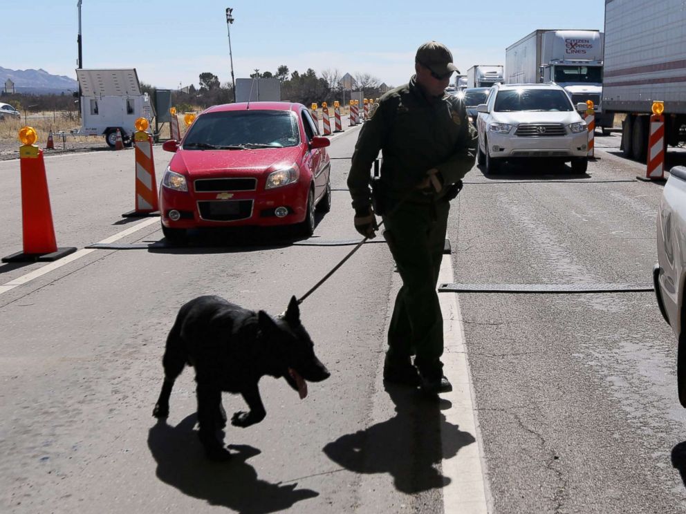 PHOTO: A U.S. Border Patrol agent and drug sniffing German Shepherd prepare to search vehicles for drugs at a checkpoint near the U.S. Mexico border on Feb. 26, 2013 north of Nogales, Ariz.