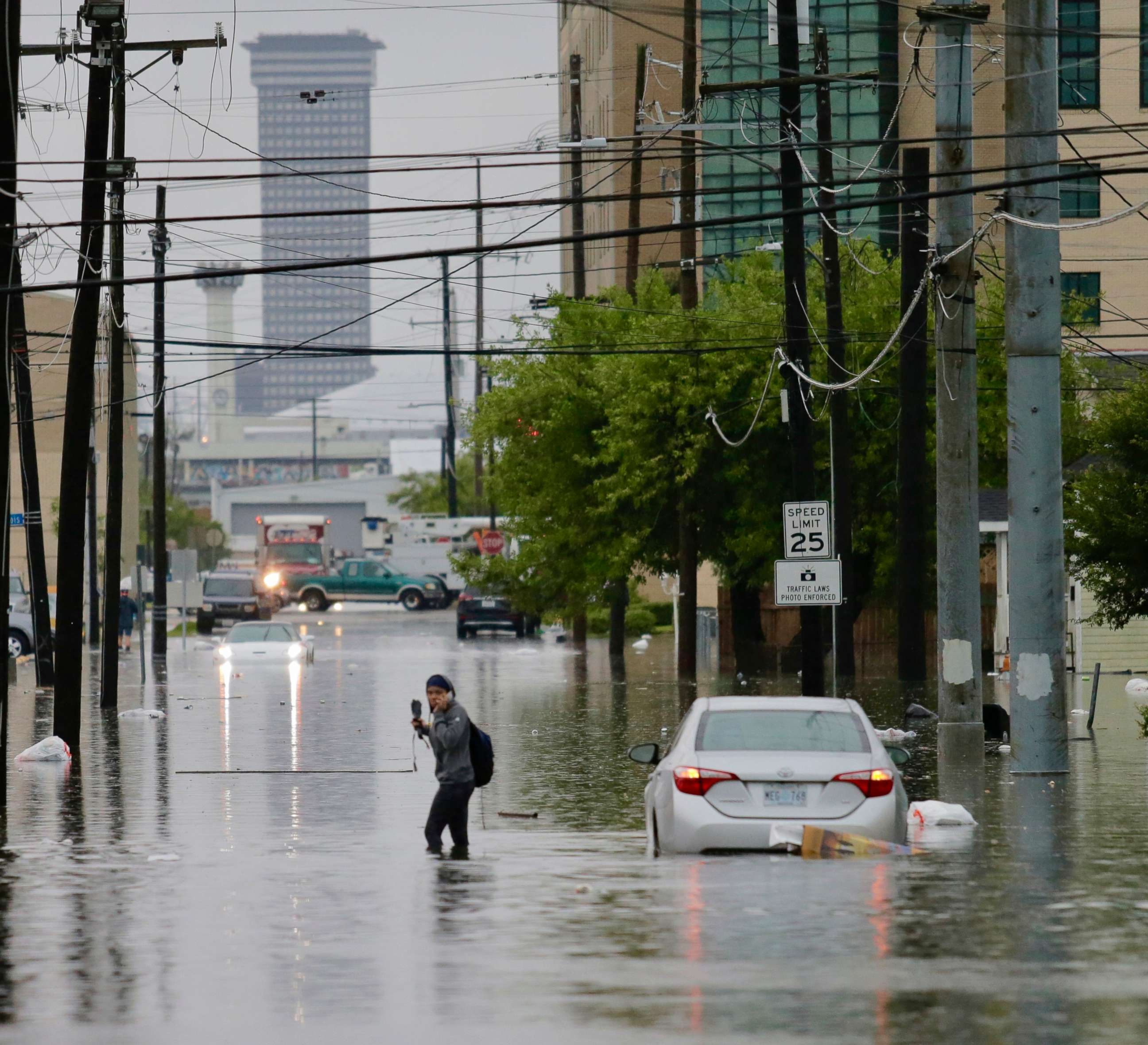 PHOTO: A person crosses a flooded road as heavy rain falls, July 10, 2019, in New Orleans.