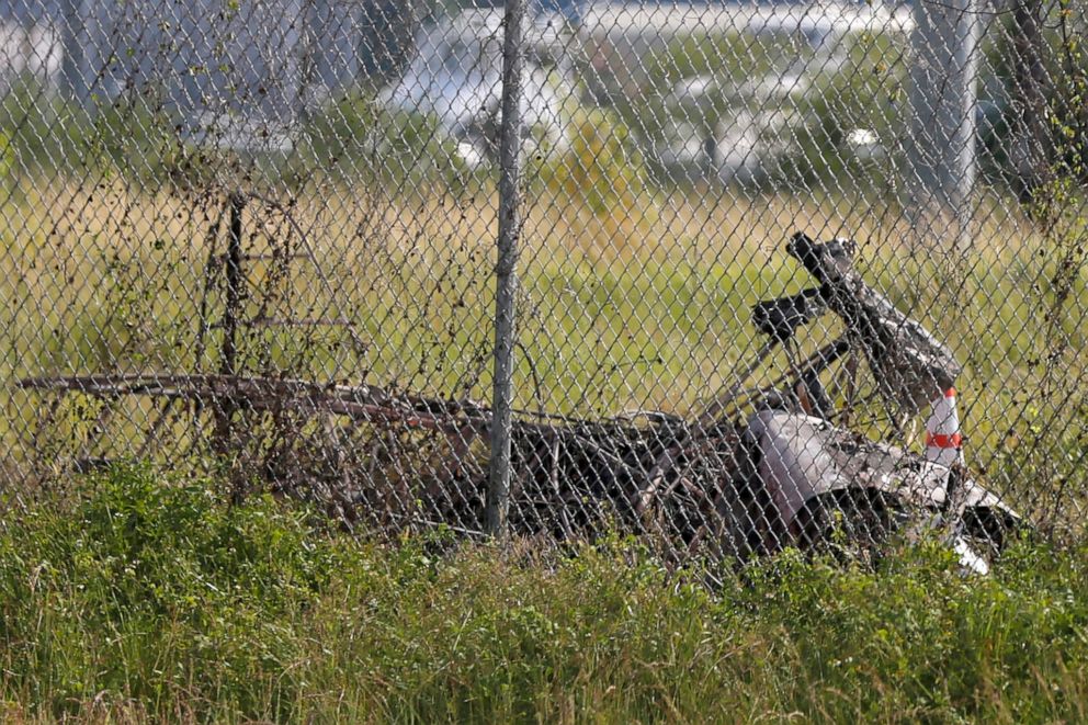 PHOTO: The charred wreckage of a private plane is seen in a field near the Industrial Canal and New Orleans Lakefront airport, in New Orleans, Friday, Aug. 16, 2019.