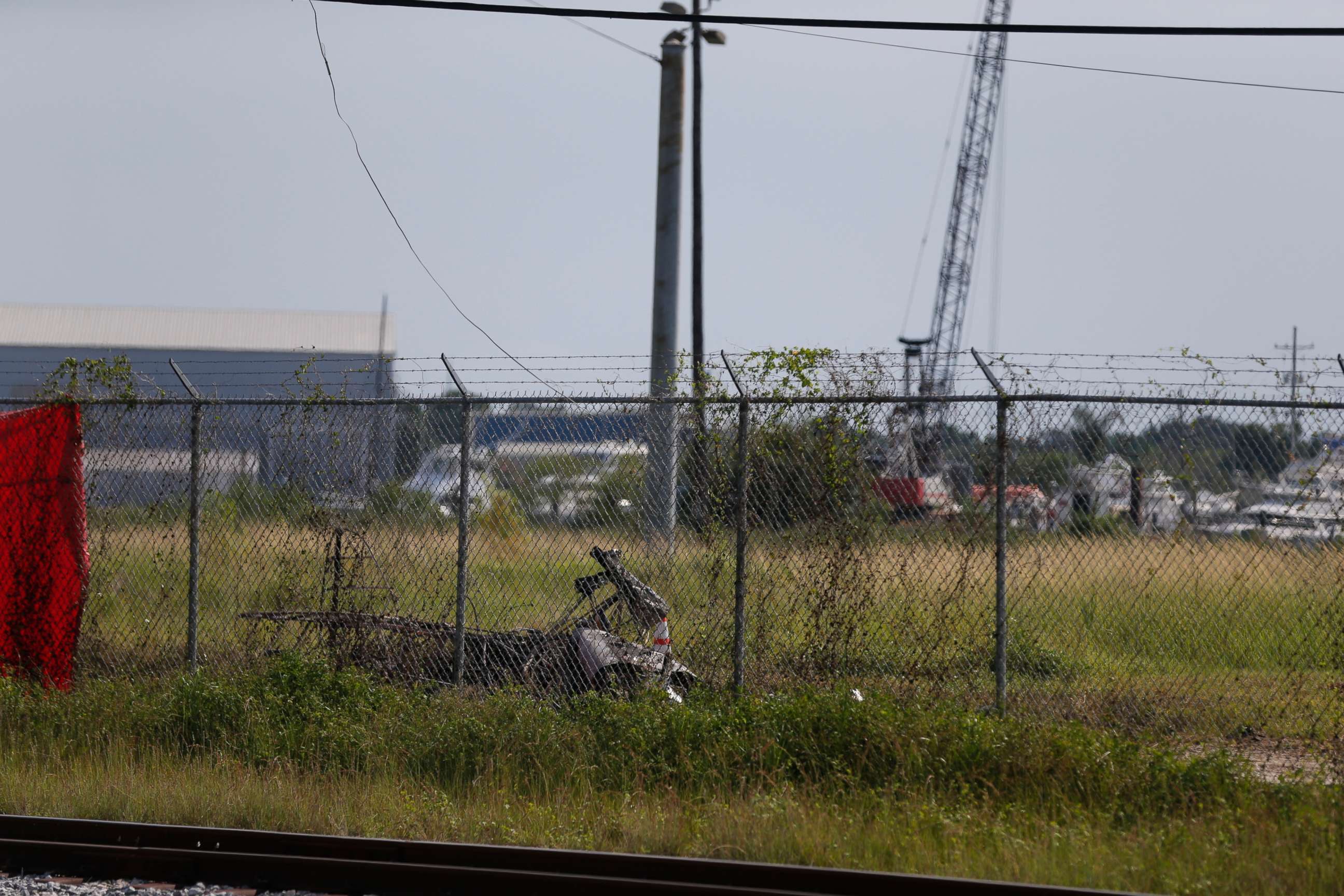 PHOTO: The charred wreckage of a private plane is seen in a field near the Industrial Canal and New Orleans Lakefront airport, in New Orleans, Friday, Aug. 16, 2019.