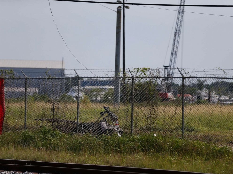 PHOTO: The charred wreckage of a private plane is seen in a field near the Industrial Canal and New Orleans Lakefront airport, in New Orleans, Friday, Aug. 16, 2019.