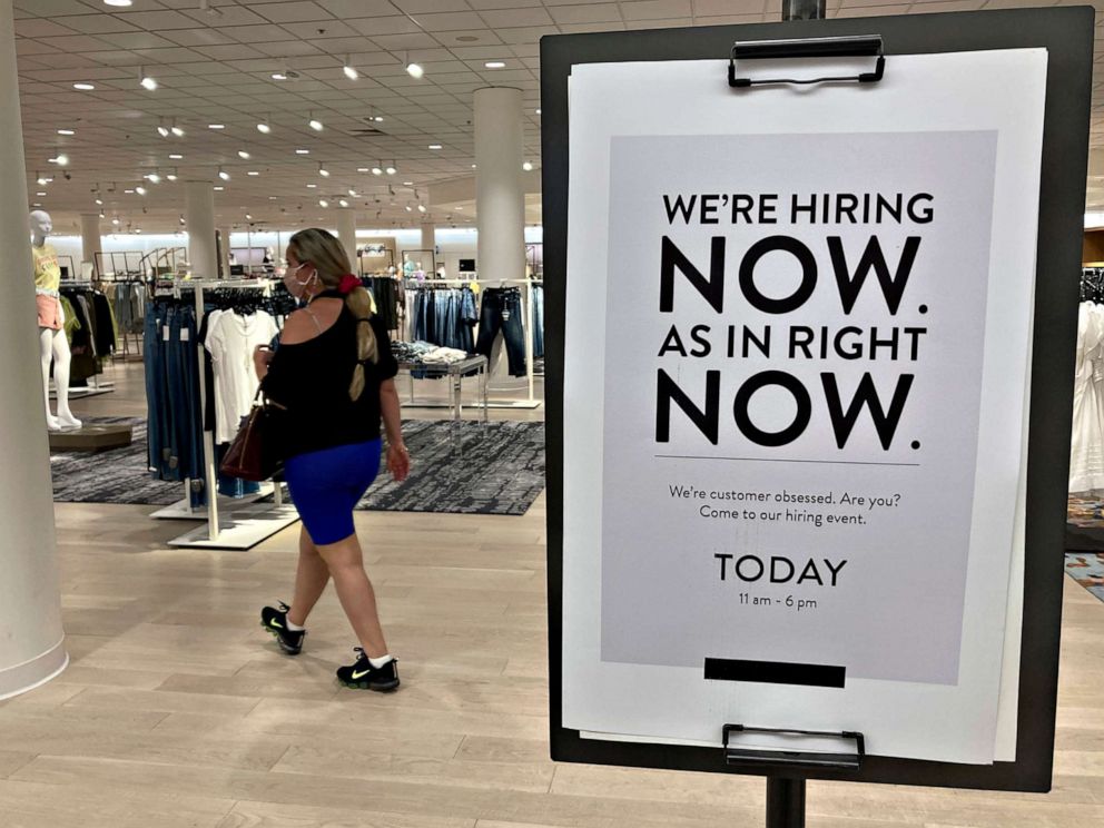 PHOTO: A customer walks behind a sign at a Nordstrom store seeking employees, May 21, 2021, in Coral Gables, Fla.