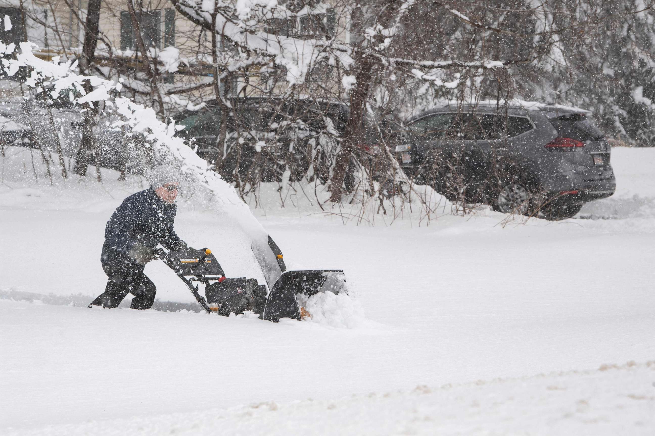 PHOTO: A person tries to use a snowblower to clear snow from their driveway, over a foot deep, during a noreaster in Rutland, Massachusetts on March 14, 2023.