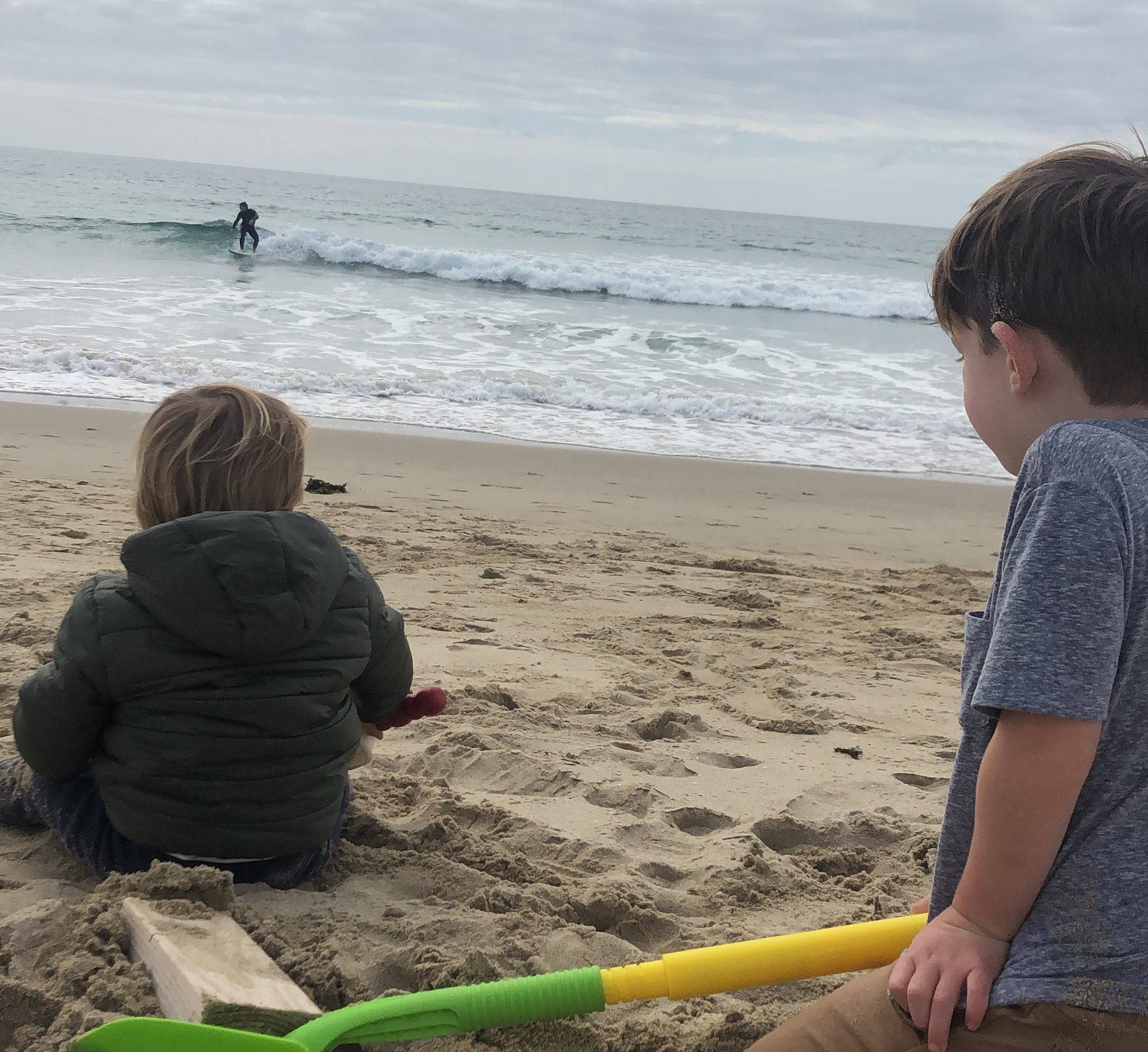 PHOTO: Lindsey Burrell reflected on a photo from the last moment of normalcy before her life and work were affected by coronavirus - a photo from March 15 of her kids, a four-year-old and an 18-month-old, sitting on the beach, watching their dad surf. 