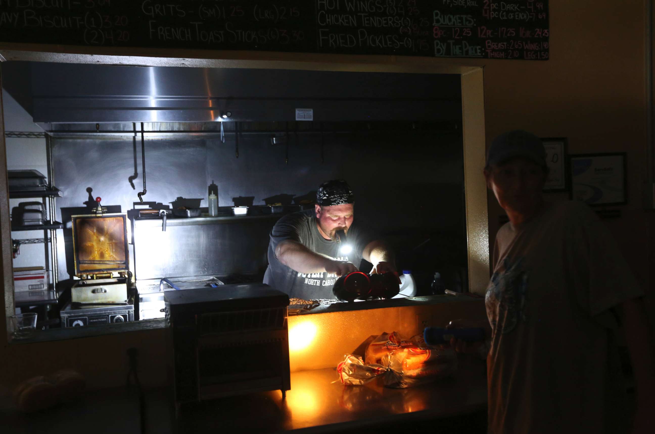PHOTO: Aaron Howe cooks in the dark kitchen at the Island Convenience Store in Rodanthe on Hatteras Island, N.C., July 28, 2017. 