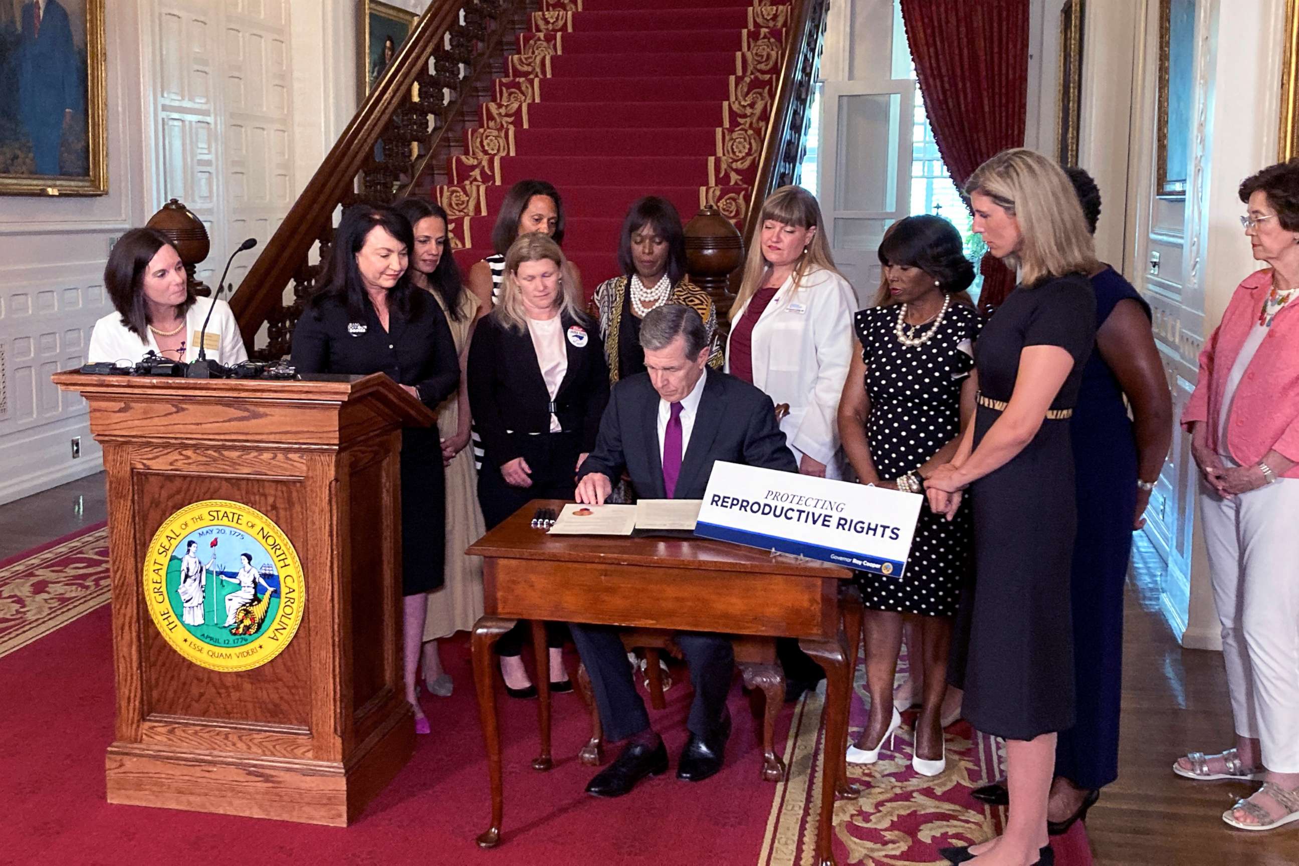 PHOTO: North Carolina Democratic Gov. Roy Cooper signs an executive order designed to protect abortion rights in the state at the Executive Mansion in Raleigh, N.C. on July 6, 2022.