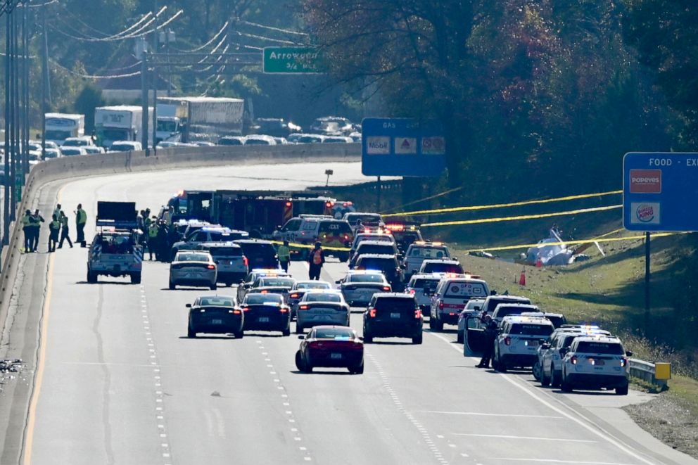 PHOTO: Emergency personnel work at the scene of a helicopter crash on the side of Interstate 77 South in Charlotte, N.C., on Nov. 22, 2022. Authorities said two people died.
