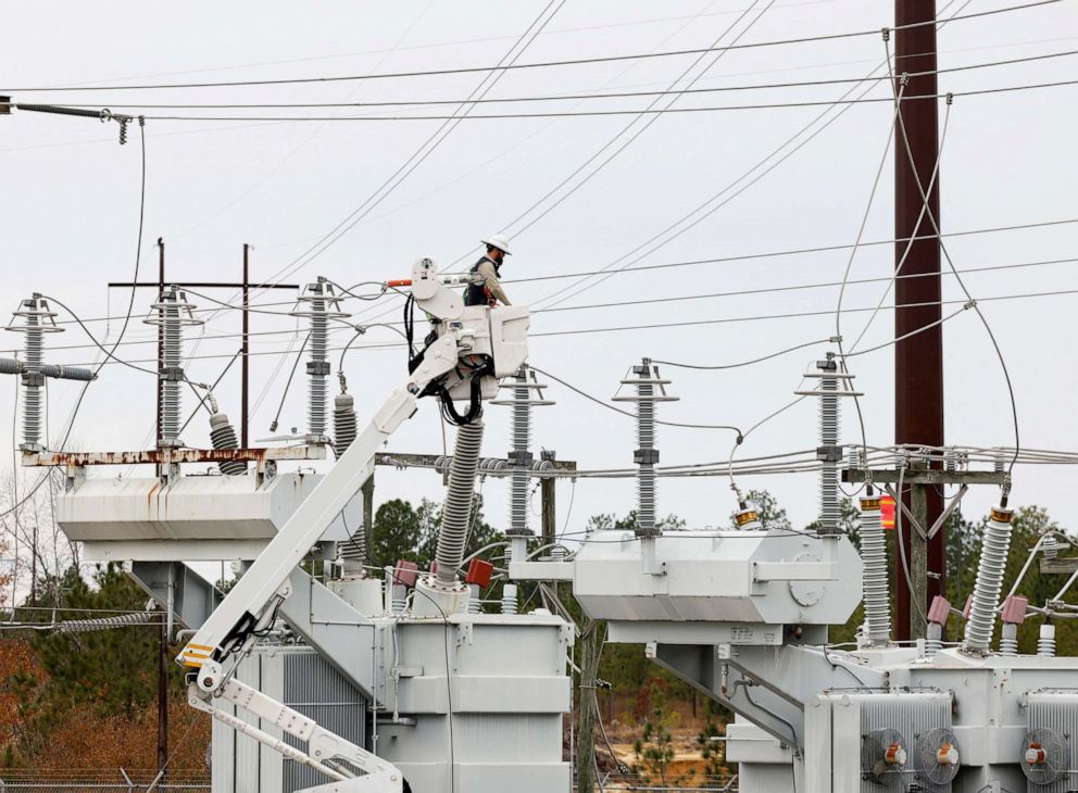 PHOTO: Duke Energy crews work to restore power at another crippled electrical substation after the Moore County Sheriff said vandalism caused a mass power outage in Carthage, NC, on Dec. 4, 2022. 