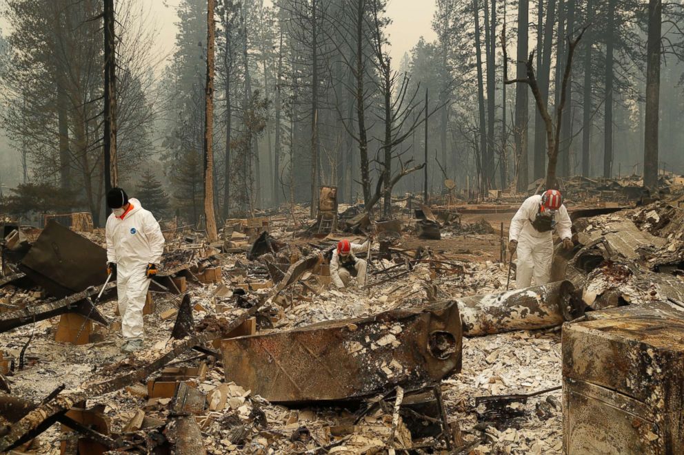 PHOTO: Search and rescue workers search for human remains at a trailer park burned by the Camp Fire, Nov. 13, 2018, in Paradise, Calif. 