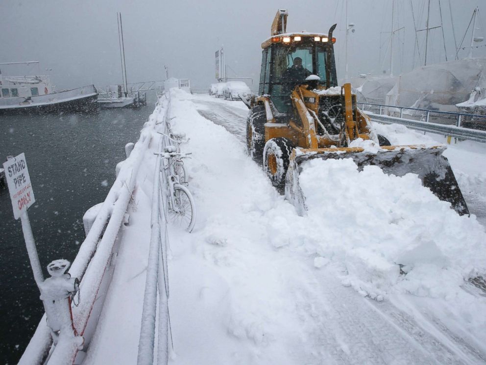 PHOTO: A front end loader clears the pier at the Boston Harbor Shipyard and Marina in Boston, March 13, 2018.