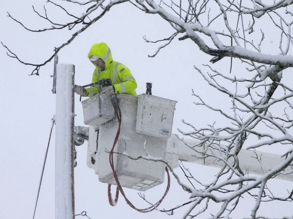 PHOTO: A worker repairs power lines during a winter storm, March 13, 2018, in Norwell, Mass.
