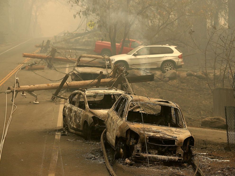 PHOTO: Power lines rest on cars that were burned by the Camp Fire on Nov. 10, 2018 in Paradise, Calif.