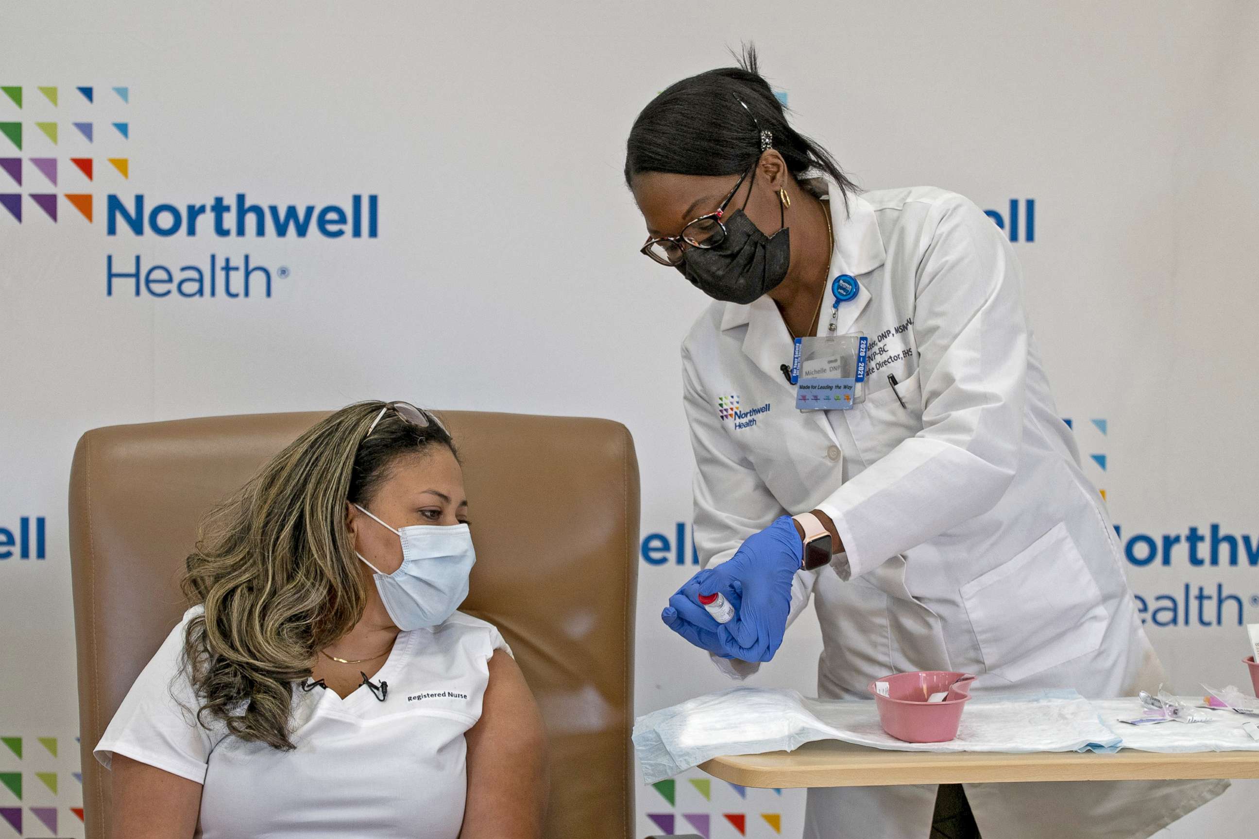 PHOTO: Dr. Michelle Chester prepares to administer the Moderna vaccine to registered nurse Arlene Ramirez, the first frontline worker to be inmunized at Long Island Jewish Valley Stream hospital in Valley Stream, N.Y., Dec. 21, 2020.