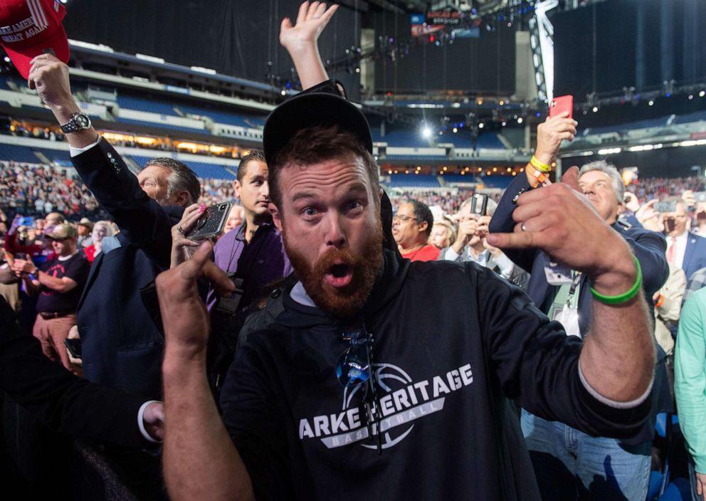 PHOTO: A man gestures towards the press corps after throwing an object on stage as President Donald Trump arrived to speak at the National Rifle Association Annual Meeting at Lucas Oil Stadium in Indianapolis, April 26, 2019.