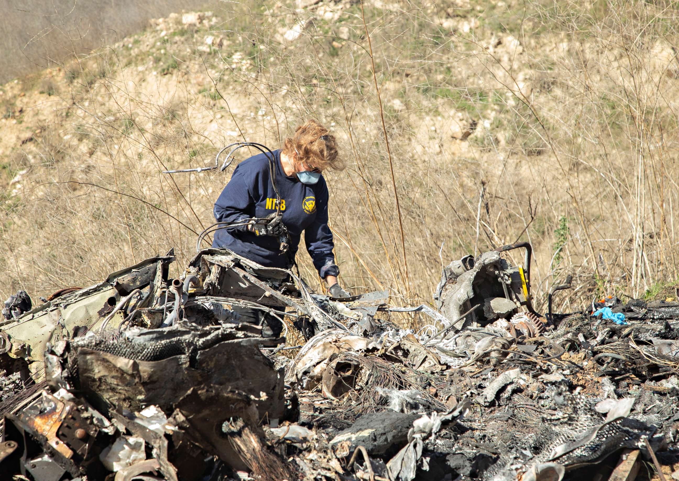 PHOTO: Photo taken Jan. 27, 2020, shows National Transportation Board (NTSB) investigator Carol Hogan examining the wreckage of the Jan. 26 helicopter crash near Calabasas, Calif., which killed nine people, including Kobe Bryant and his daughter Gianna.