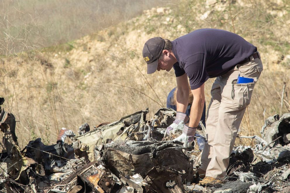PHOTO: Photo taken Jan. 27, shows National Transportation Board (NTSB) investigator Adam Huray examining the wreckage of the Jan. 26 helicopter crash near Calabasas, Calif., which killed nine people, including Kobe Bryant and his daughter Gianna.