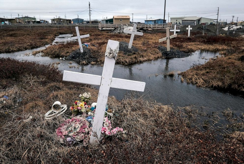  FILE - Water surrounds displaced graves at the cemetery in Nuiqsut, AK, May 30, 2019.