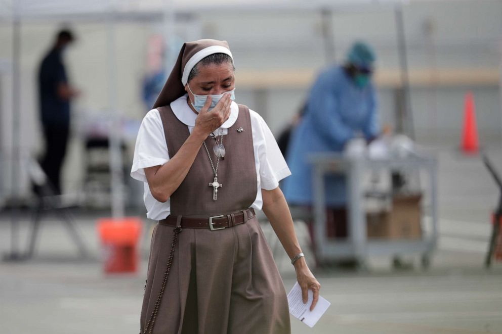 PHOTO: A nun with the Saint Ann Mission, who declined to give her name, leaves a COVID-19 testing site after being tested at the Martin Luther King, Jr. Clinica Campesina Health Center in Homestead, Florida, on July 6, 2020.