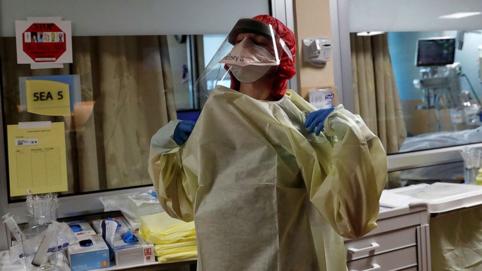 PHOTO: Registered nurse Kelsey Simons pauses while putting on her personal protective equipment (PPE) gear before treating a coronavirus disease (COVID-19) positive patient at Sarasota Memorial Hospital in Sarasota, Florida, Sept. 21, 2021.