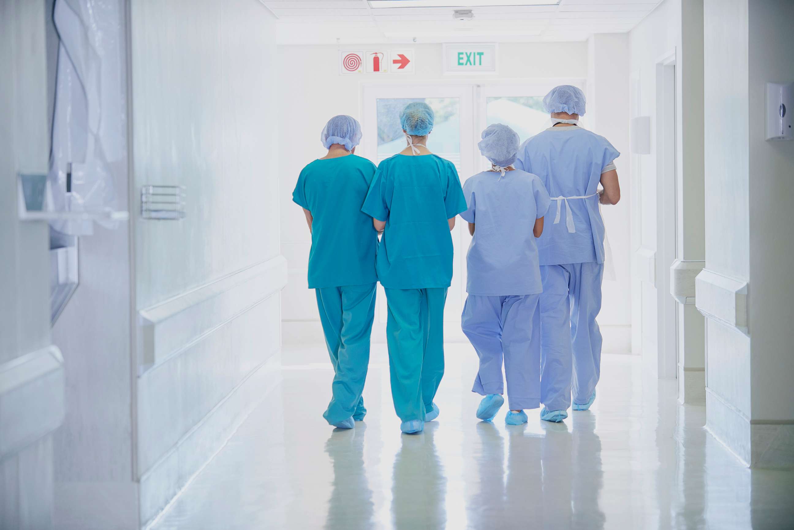 PHOTO: A rear view of four medical staff wearing scrubs is seen in this undated stock photo.