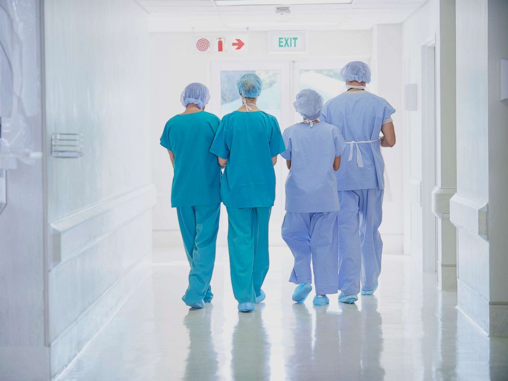 PHOTO: A rear view of four medical staff wearing scrubs is seen in this undated stock photo.