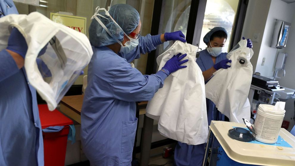 PHOTO: Nurses clean personal protective equipment (PPE) after being part of a team that performed a procedure on a coronavirus COVID-19 patient in the intensive care unit at Regional Medical Center on May 21, 2020 in San Jose, California. 