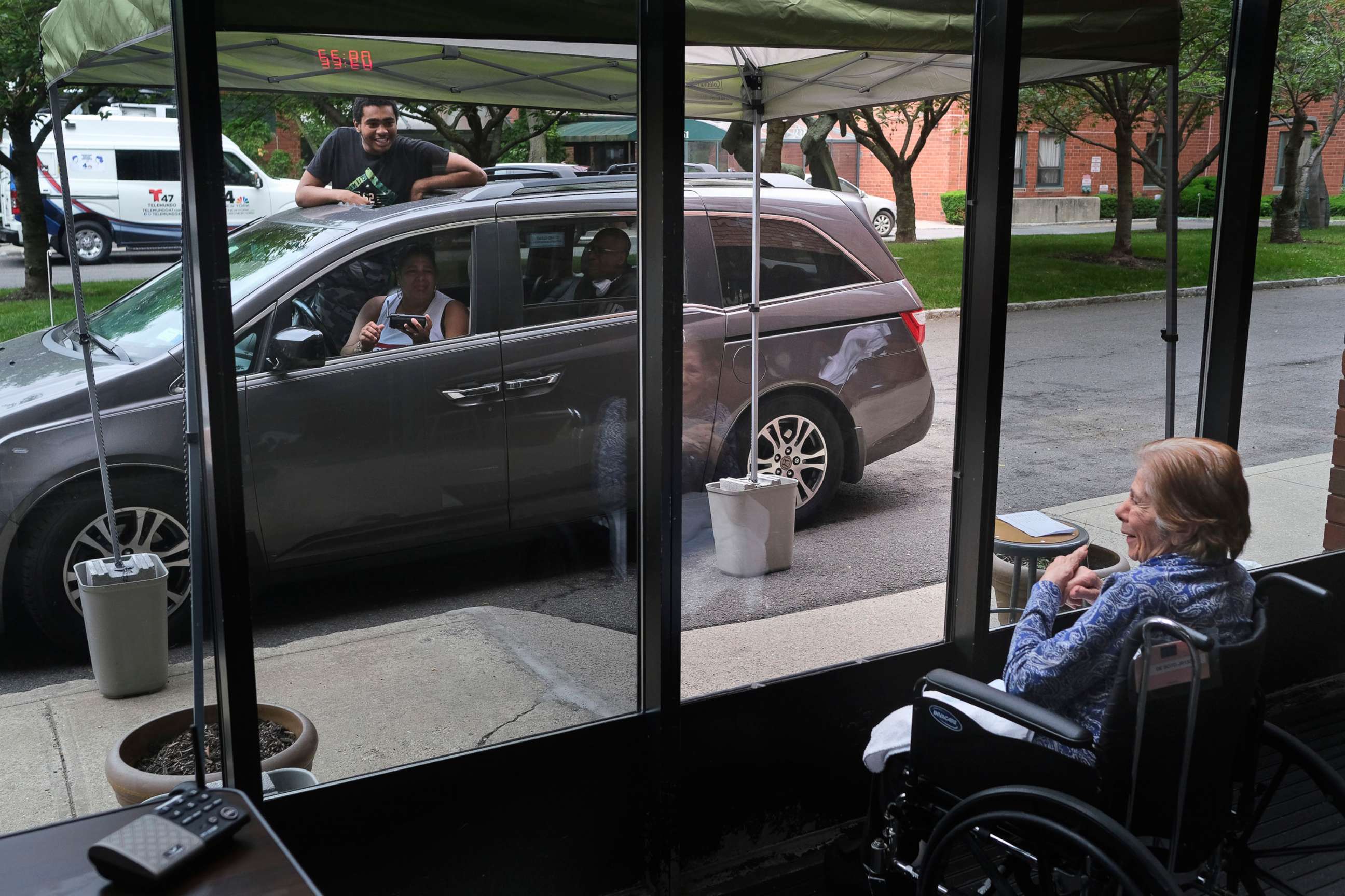 PHOTO: In this June 11, 2020, file photo, Gloria DeSoto, 92, right, visits with her family, in their car, from a window of the Hebrew Home at Riverdale, where she lives, in New York.