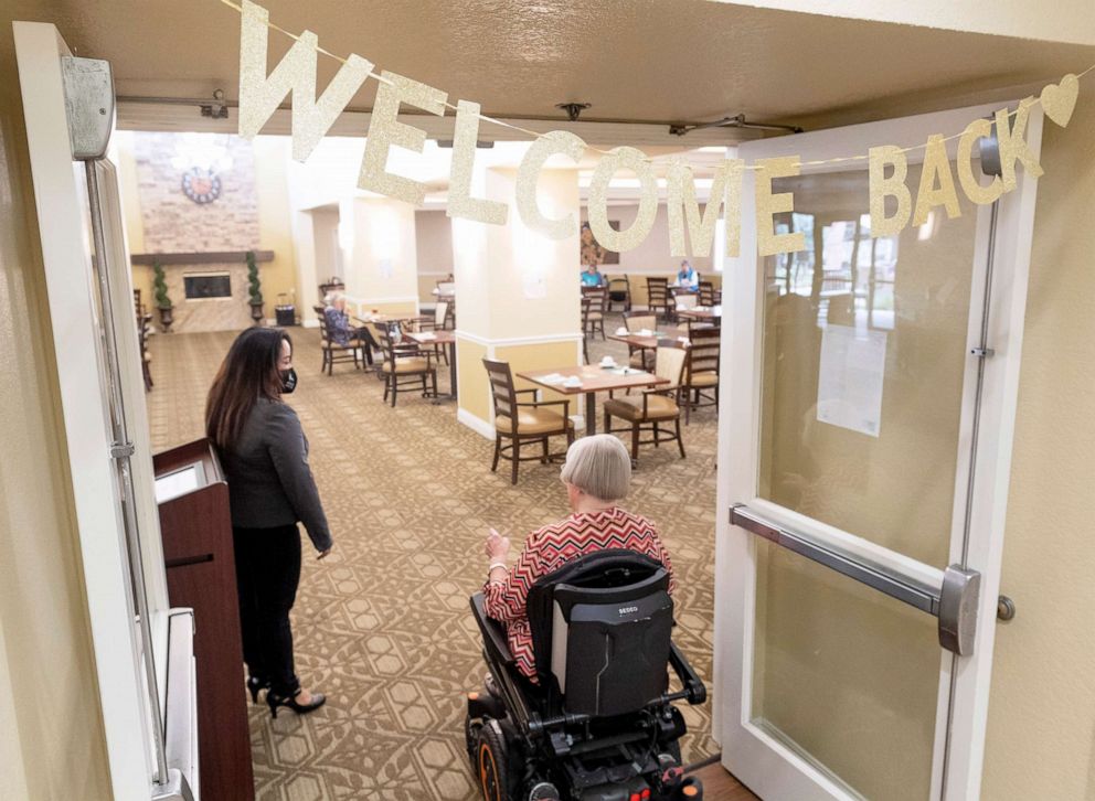 PHOTO: Residents are greeted at the dining room at Emerald Court senior living facility in Anaheim, Calif., March 8, 2021.