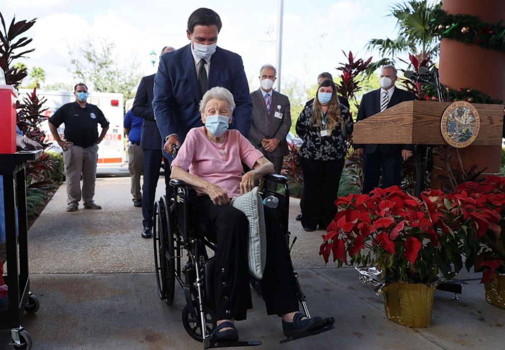 PHOTO: Florida Gov. Ron DeSantis pushes Vera Leip, 88, in her wheelchair after she received a Pfizer-BioNtech COVID-19 vaccine at the John Knox Village Continuing Care Retirement Community, Dec. 16, 2020, in Pompano Beach, Florida.