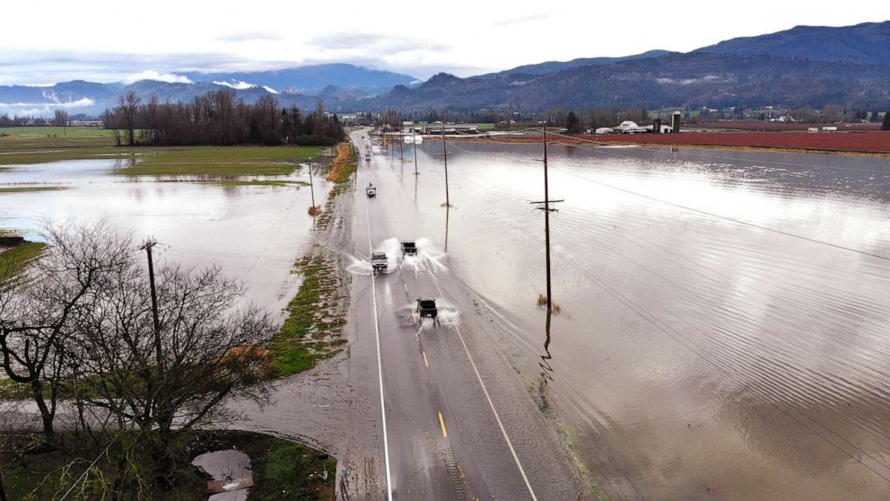 PHOTO: Vehicles navigate a flooded highway headed into Sumas, Wash., Nov. 29, 2021. 