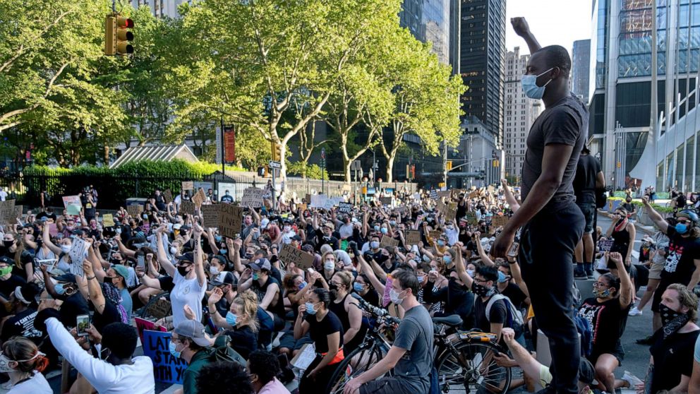 PHOTO: A group of protesters take a knee while marching in lower Manhattan Saturday, June 6, 2020, in New York.