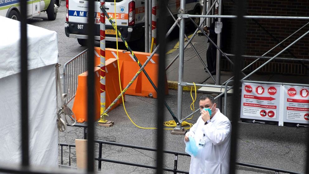 PHOTO: A doctor puts a face mask on before entering the coronavirus testing test area outside of Brooklyn Hospital on April 2, 2020 in New York City.