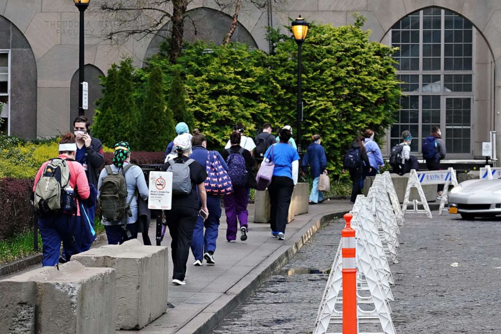 PHOTO: Medical staff arrive for their shift at NewYork-Presbyterian Hospital/Weill Cornell Medical Center during the coronavirus pandemic, April 13, 2020 in New York.