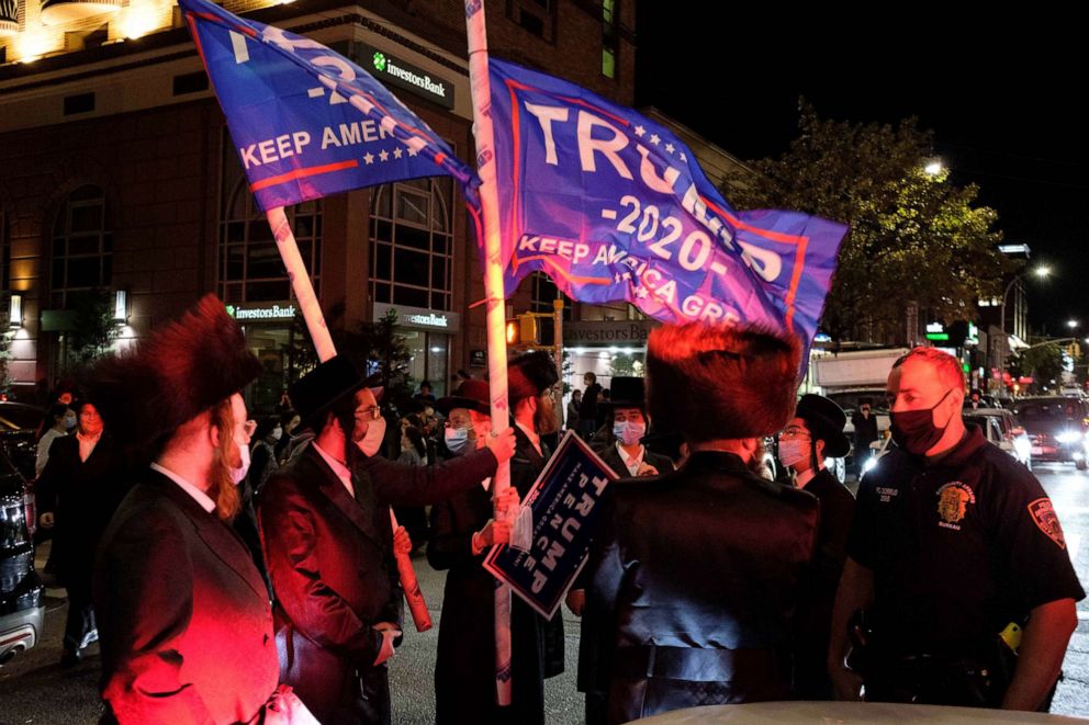 PHOTO: Ultra-Orthodox Jews wave Trump flags as they gather in Borough Park, Brooklyn to protest against coronavirus disease (COVID-19) restrictions in New York, Oct. 7, 2020.