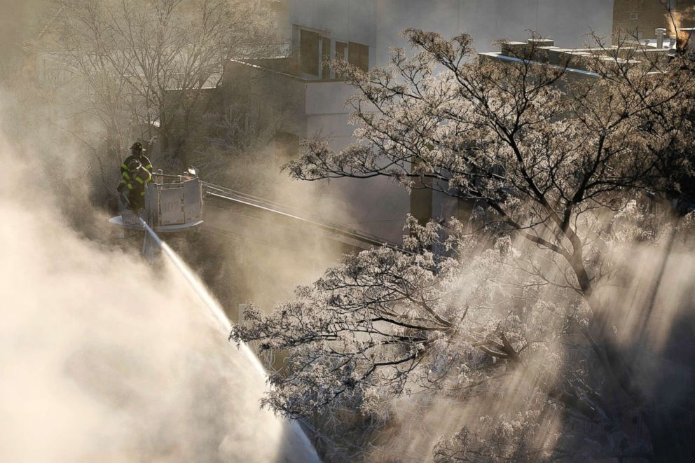 PHOTO: Ice forms on tree branches as New York firefighters battle a blaze in a commercial building in the Bedford Stuyvesant neighborhood of Brooklyn, Jan. 31, 2019, in N.Y.