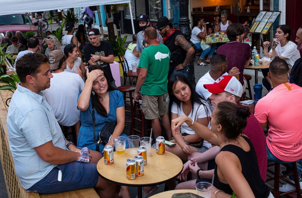 PHOTO: Customers at a sidewalk restaurant use outdoor seating permitted by the Phase 2 opening July 17, 2020 along Smith Street in the Brooklyn borough of New York City.