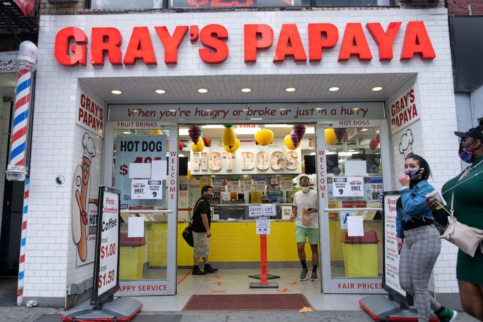 PHOTO: People wearing face masks as a preventive measure order food at Greys Papaya in Manhattan amid the coronavirus pandemic.