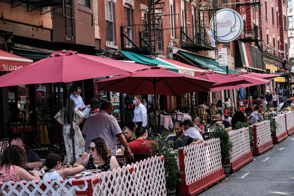 PHOTO: People dine al fresco in Little Italy on Mulberry Street between Hester and Broome Streets on July 4, 2020 in the Manhattan borough of New York City.