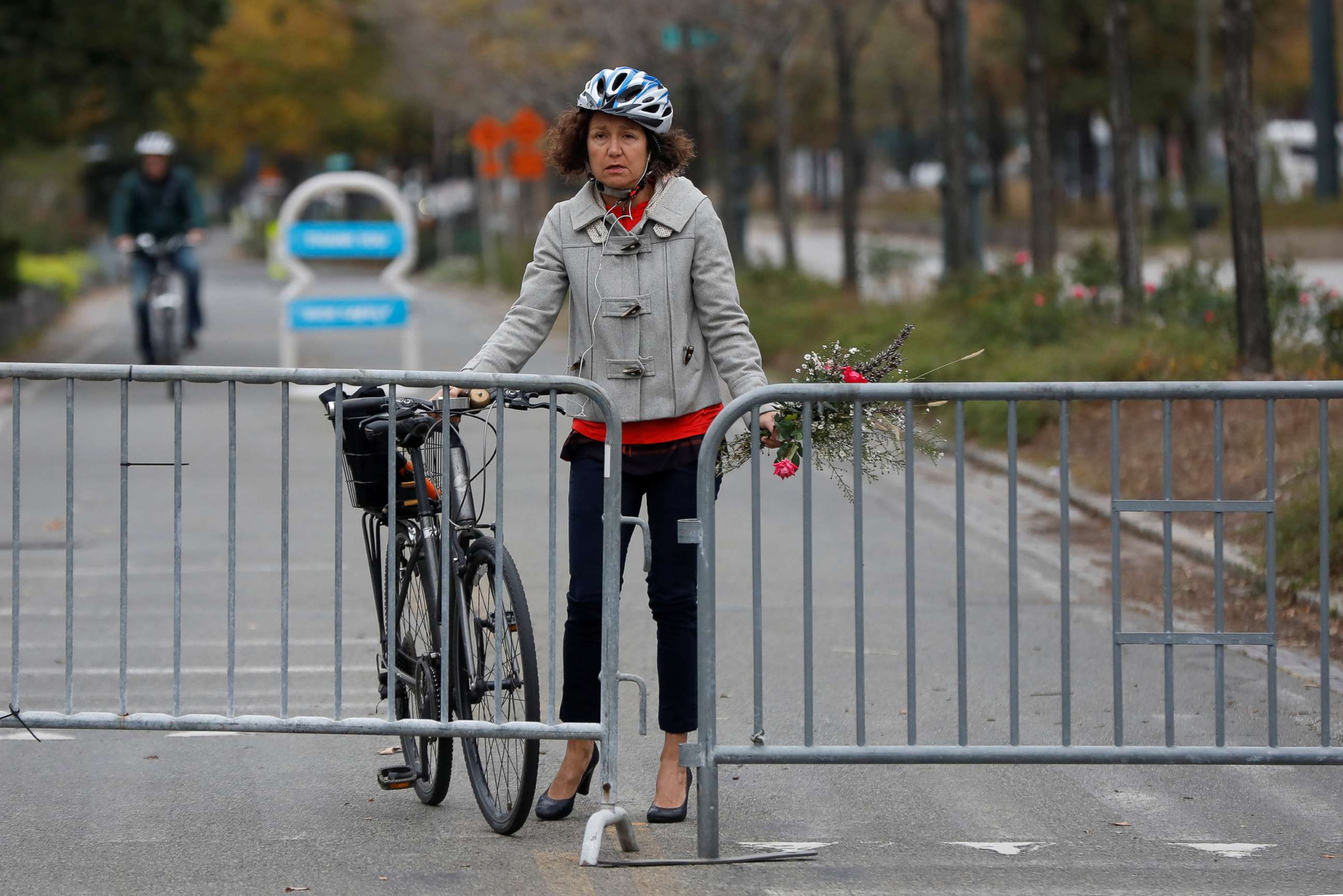PHOTO: Celia Imrey carries flowers to lay for victims of Tuesday's attack outside a police barricade on the bike path a day after a man mowed down pedestrians and cyclists on a bike path alongside the Hudson River in New York City, Nov. 1, 2017. 