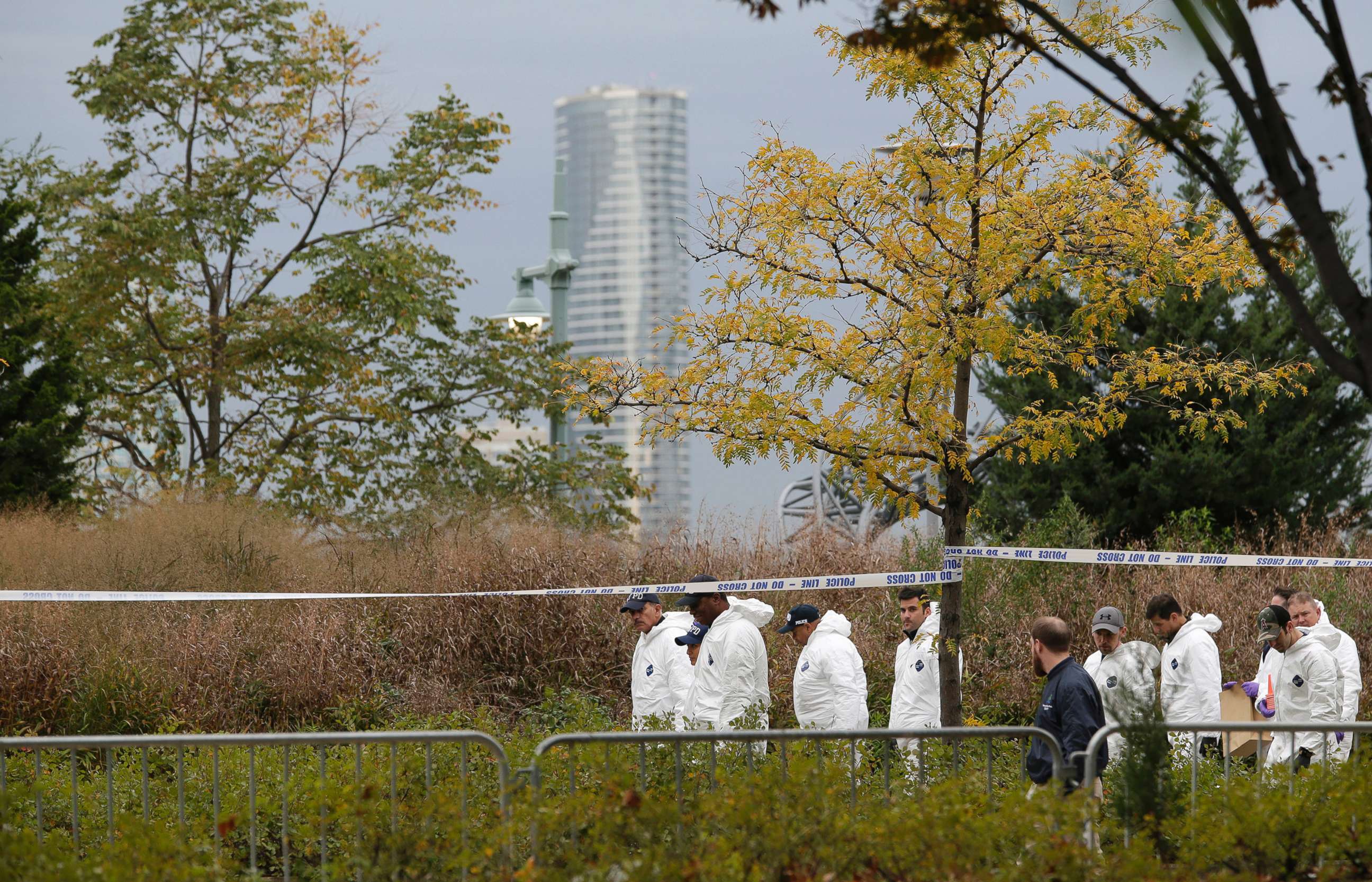 PHOTO: Crime scene investigators walk along the west side bike path in lower Manhattan, New York,  Nov. 1, 2017, a day after a truck plowed down the path pedestrians and cyclists. 