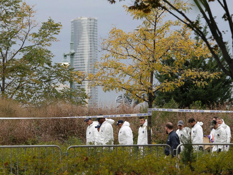 PHOTO: Crime scene investigators walk along the west side bike path in lower Manhattan, New York, Nov. 1, 2017, a day after a truck plowed down the path pedestrians and cyclists.