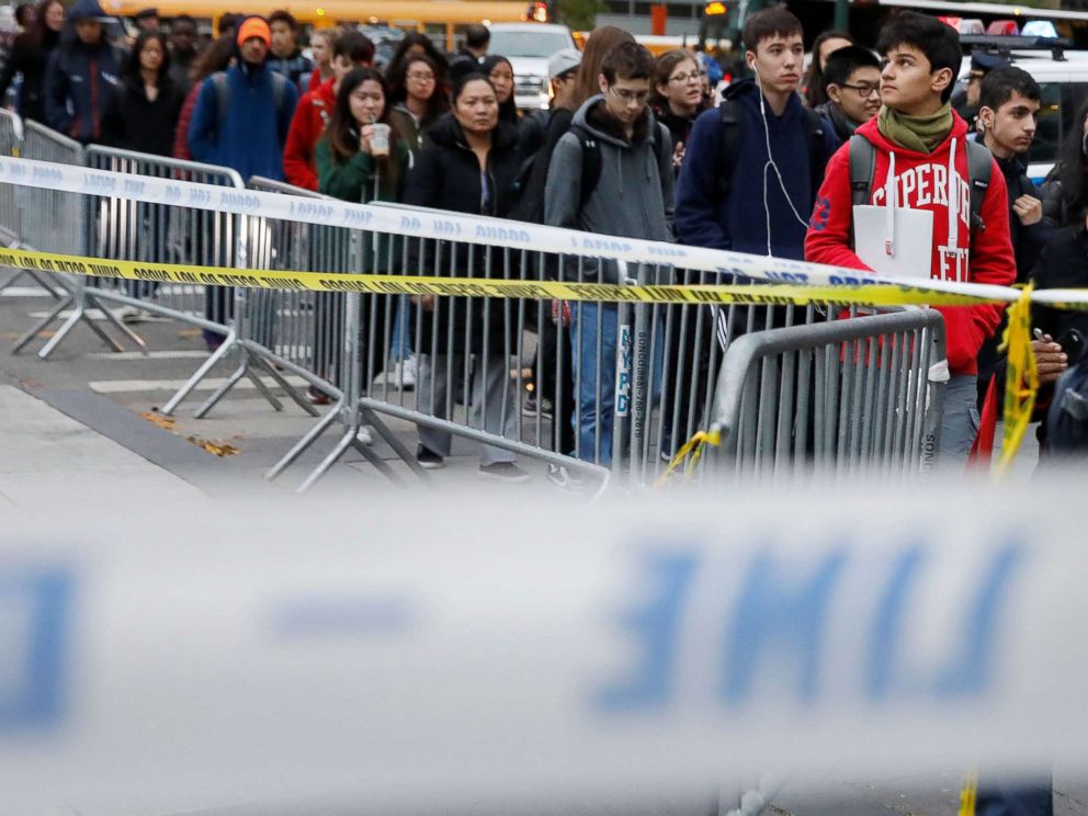 PHOTO: Students walk past police line tape on their way to school a day after a man driving a rented pickup truck mowed down pedestrians and cyclists on a bike path alongside the Hudson River in New York City, Nov. 1, 2017.