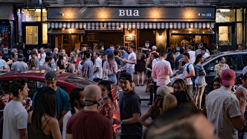 PHOTO: People drink outside a bar during the reopening phase following the coronavirus outbreak in the East Village neighborhood in New York City, June 12, 2020.