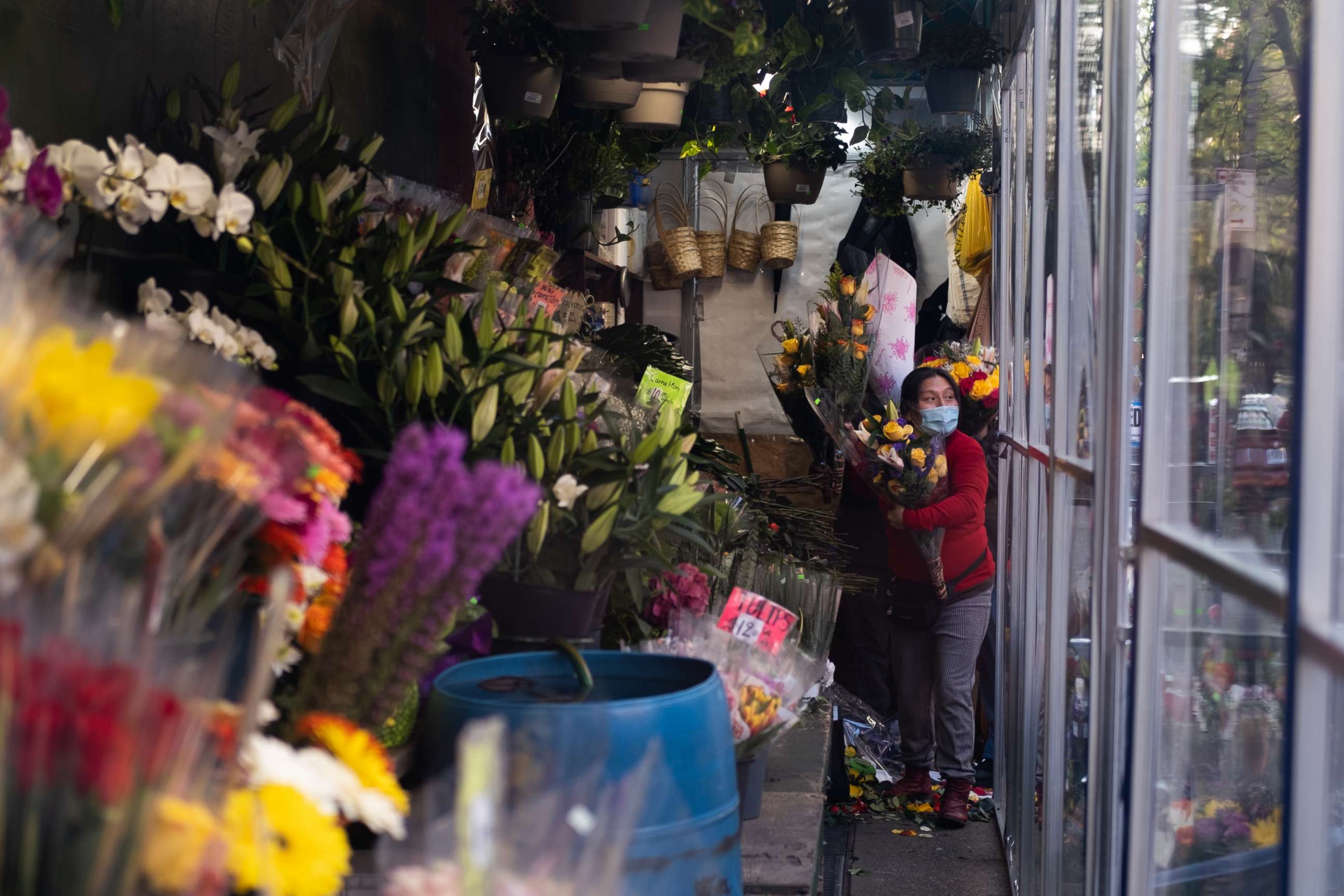 PHOTO: A woman holds flowers inside a bodega on May 10, 2020 in New York City. 