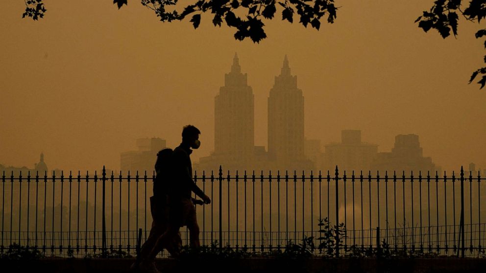 PHOTO: People walk in Central Park as smoke from wildfires in Canada turn skies a hazy orange, June 7, 2023, in New York City.