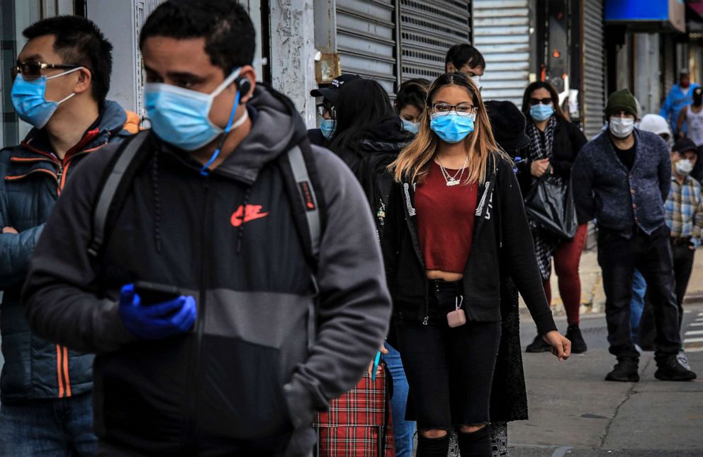 PHOTO: People wear masks and maintain social distance to help stop the spread of coronavirus, while waiting in line to enter a store in Sunset Park, a Brooklyn neighborhood of New York, May 5, 2020.