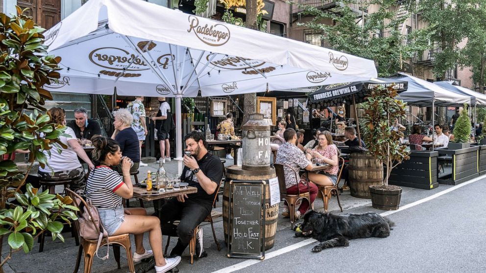 PHOTO: People enjoy al fresco dining at a bar as the coronavirus kept restaurants from offering indoor dining, July 5, 2020, in New York City.