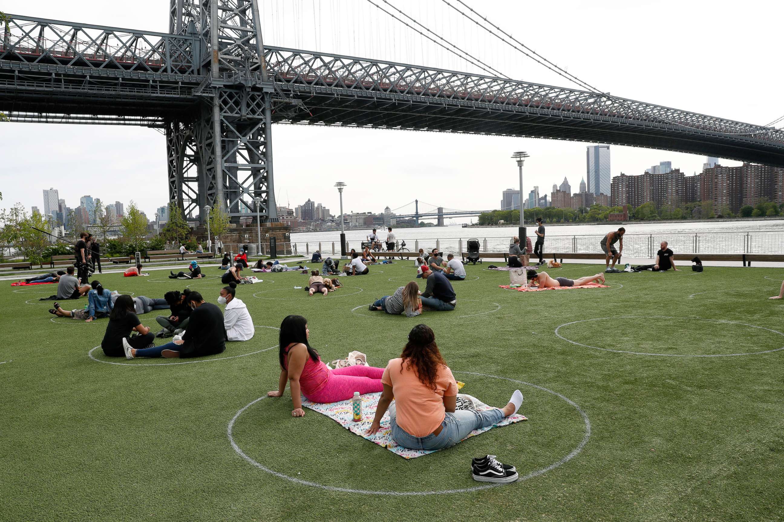 PHOTO: People relax in circles marked on the grass for proper social distancing at Brooklyn's Domino Park during the coronavirus outbreak, May 18, 2020, in New York.